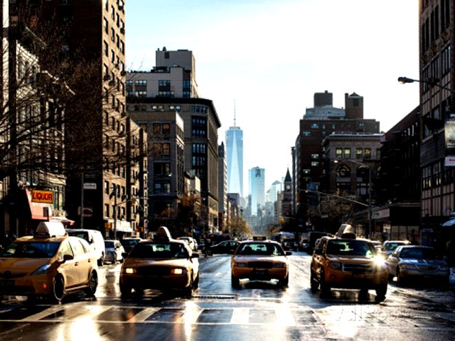 Urban Street Scene with NYC Yellow Taxis and the One World Trade Center of Manhattan in Winter